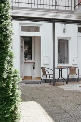 a patio with two chairs and a table at Apartments Tivoli in Ljubljana