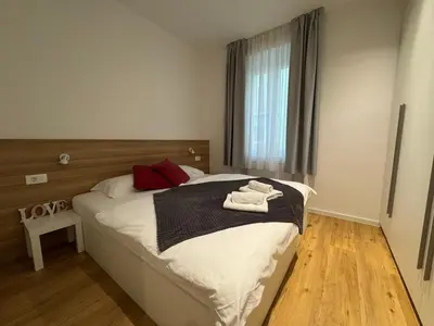 a bedroom with a bed with two towels on it at Apartments Tivoli in Ljubljana