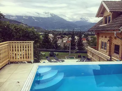a swimming pool with a view of a mountain at Planika Holiday Home in Bled