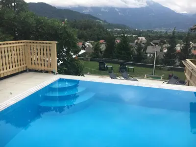 a swimming pool with a view of a mountain at Planika Holiday Home in Bled