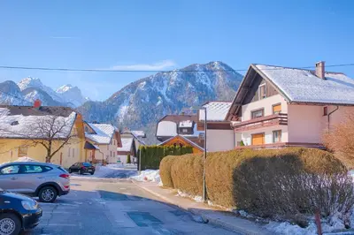 a small town with houses and mountains in the background at Apartments and Rooms Banić in Kranjska Gora