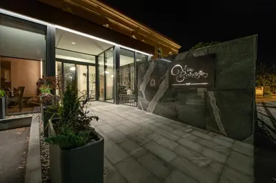 a store with a sign on the side of a building at Hotel Vila Pohorje in Slovenj Gradec