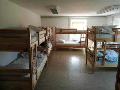a room with a bunch of bunk beds at Počitniška hiša Ostrnica in Hrib-Loški Potok