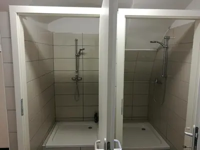 a bathroom with a shower and a bath tub at Počitniška hiša Ostrnica in Hrib-Loški Potok