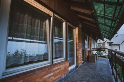 a porch of a house with windows on it at Apartmaji Retro in Spodnje Gorje