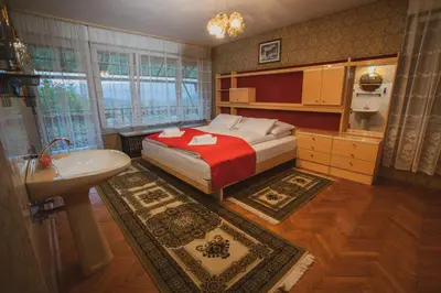 a bedroom with a bed and a sink and a bathroom at Apartmaji Retro in Spodnje Gorje