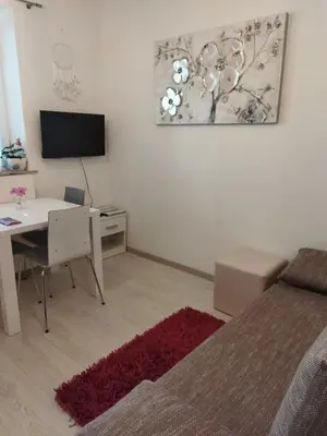 a bedroom with a desk and a table with a computer at Apartma JERMAN - Cerknica in Cerknica