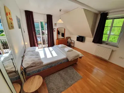 a bedroom with a bed and a television in it at Apartman Irvin in Kranjska Gora