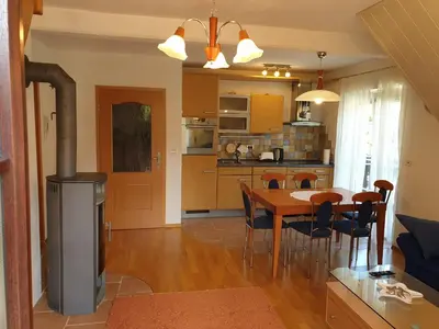 a kitchen and dining room with a table and chairs at Apartman Irvin in Kranjska Gora