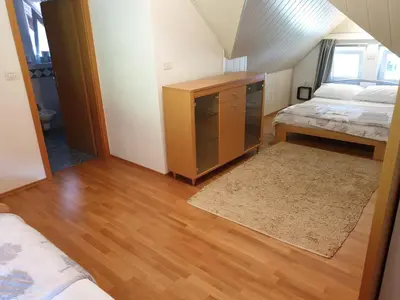 a bedroom with a bed and a dresser in a room at Apartman Irvin in Kranjska Gora