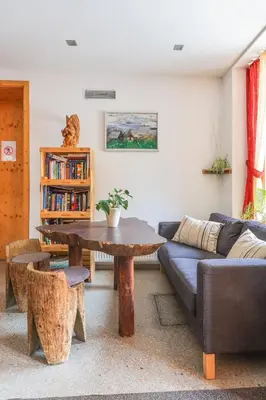 a living room with a couch and a table at Hotel Jelka Pokljuka in Goreljek