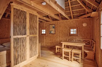 a wooden cabin with a table and chairs in it at Pirate Bay - Terme Čatež in Čatež ob Savi