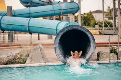 a person is coming out of a swimming pool at Pirate Bay - Terme Čatež in Čatež ob Savi