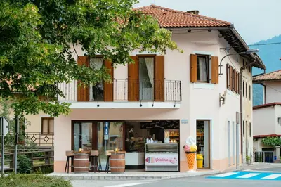 a store front of a building with a balcony at Sunny Rooms in Most na Soči