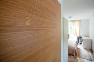 a door with a number on it in a room at Sunny Rooms in Most na Soči