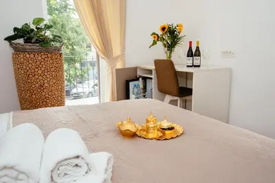 a room with a bed with a crown on it at Sunny Rooms in Most na Soči