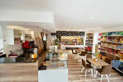 a restaurant with tables and chairs in a store at Sunny Rooms in Most na Soči