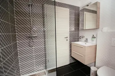 a bathroom with a shower and a sink at Sunny Rooms in Most na Soči