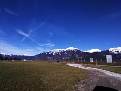 a road with snow capped mountains in the background at edelweiss in Radovljica