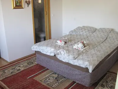 a bed with two stuffed animals laying on it at edelweiss in Radovljica