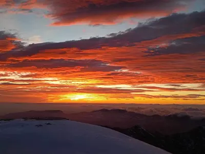 a sunset from the top of a snow covered mountain at Počitniška hiša Jeklar in Bohinj