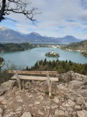 a bench sitting on top of a hill overlooking a lake at SOBE U SIRRC in Bled