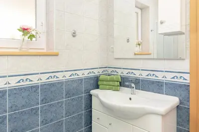 a bathroom with a sink and a mirror at Koča na Krvavcu in Cerklje na Gorenjskem