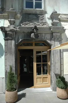 a door to a building with two potted plants in front at Vitez Apartment II in Ljubljana