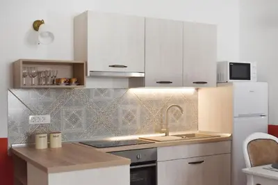 a small kitchen with white cabinets and a sink at Vitez Apartment II in Ljubljana