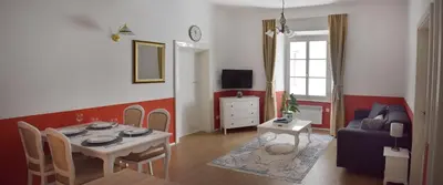 a living room with a table and a couch at Vitez Apartment II in Ljubljana