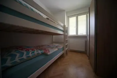 a bedroom with two bunk beds and a window at Apartment Arh in Bled