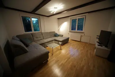 a living room with a couch and a tv at Apartment Arh in Bled