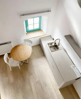 a small kitchen with a table and a sink at Lagom Home Vipavski Križ in Ajdovščina