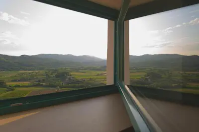 a window with a view of the countryside seen through it at Lagom Home Vipavski Križ in Ajdovščina