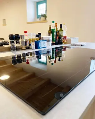 a counter with a reflection of alcohol bottles on it at Lagom Home Vipavski Križ in Ajdovščina