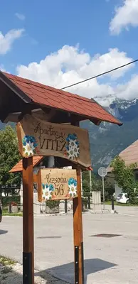 a sign with a roof on top of a street at APARTMAJI VITEZ apartma 1 in Bovec