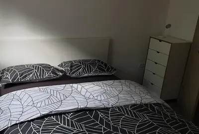 a bedroom with a bed and two pillows and a dresser at APARTMAJI VITEZ apartma 1 in Bovec