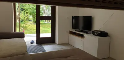 a living room with a couch and a flat screen tv at APARTMAJI VITEZ apartma 1 in Bovec
