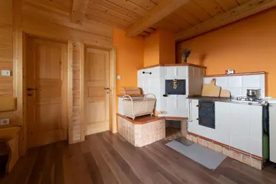 a kitchen with a toy stove in a room at Koča Zlatorog - Velika planina in Stahovica