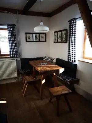 a living room with a wooden table and chairs at Cozy Private Cabin in the heart of Triglav National Park in Trenta