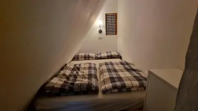 a small bedroom with a bed in a room at Cozy Private Cabin in the heart of Triglav National Park in Trenta