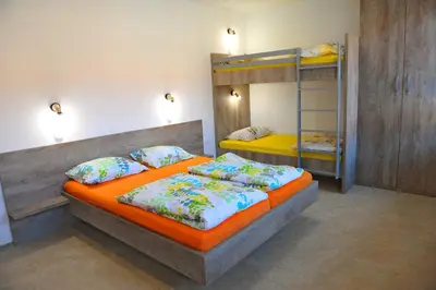 a bedroom with two beds and a bunk bed at Hostel Ormož in Ormoz