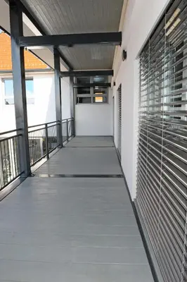 an empty corridor of a building with a balcony at Hostel Ormož in Ormoz