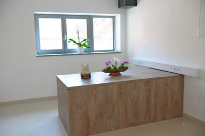 a wooden counter in a room with a window at Hostel Ormož in Ormoz