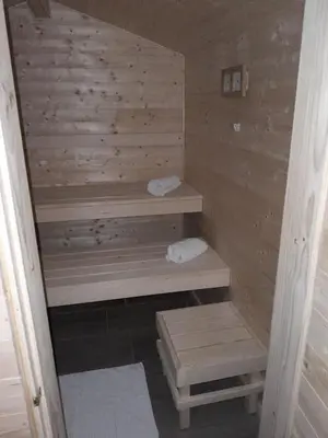 a wooden sauna with two steps and two towels at Villa Katarina in Branik