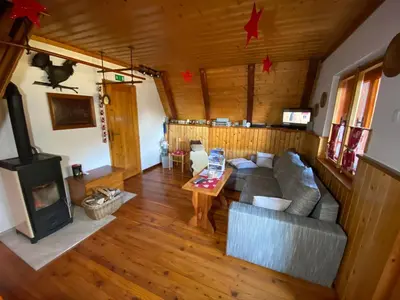 an overhead view of a living room with a couch and a wood stove at Wooden Cottage in Jesenice