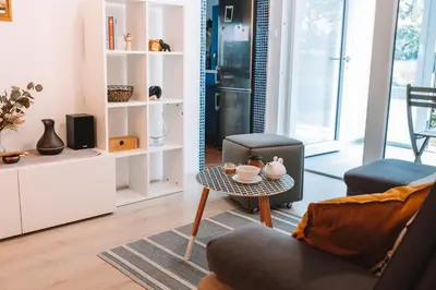 a living room with a table and a chair at Apartment with Atrium Anabela in Tolmin