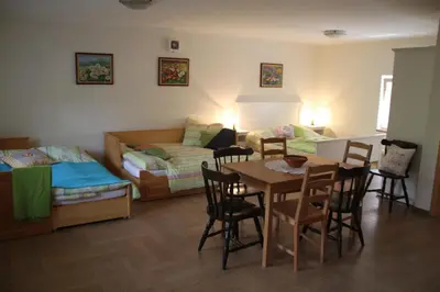 a living room with a table and chairs and a couch at Rock&Lodge in Bohinj