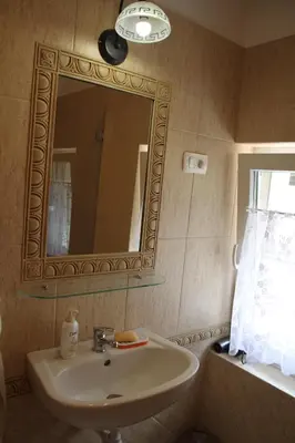a bathroom with a sink and a mirror and a window at Rock&Lodge in Bohinj