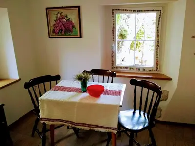 a dining room table with a red bowl on it at Rock&Lodge in Bohinj